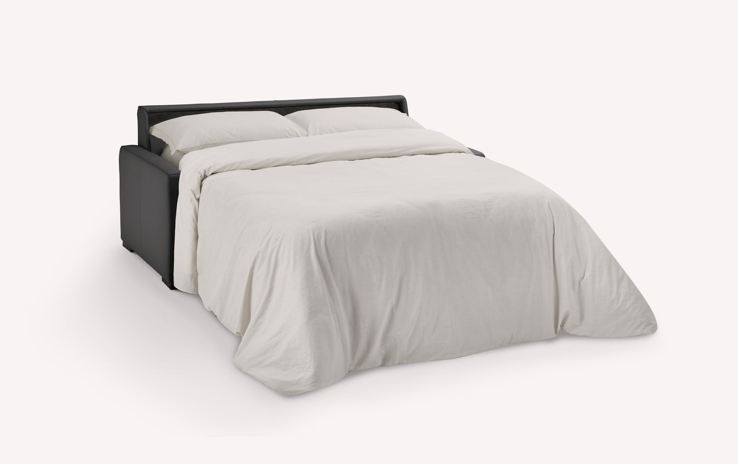 Canapé convertible en cuir noir de luxe, ouvert en position lit avec draps blancs