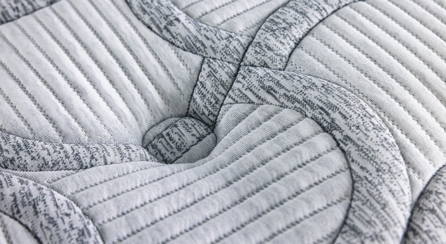 revêtement de matelas gris avec motifs géométriques et coutures visibles, associée à un packshot de la collection Amsterdam Florence