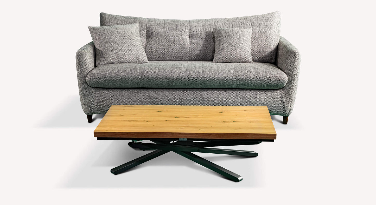 Canapé convertible gris avec coussins, accompagné d'une table basse en bois clair et pieds noirs, style moderne et épuré