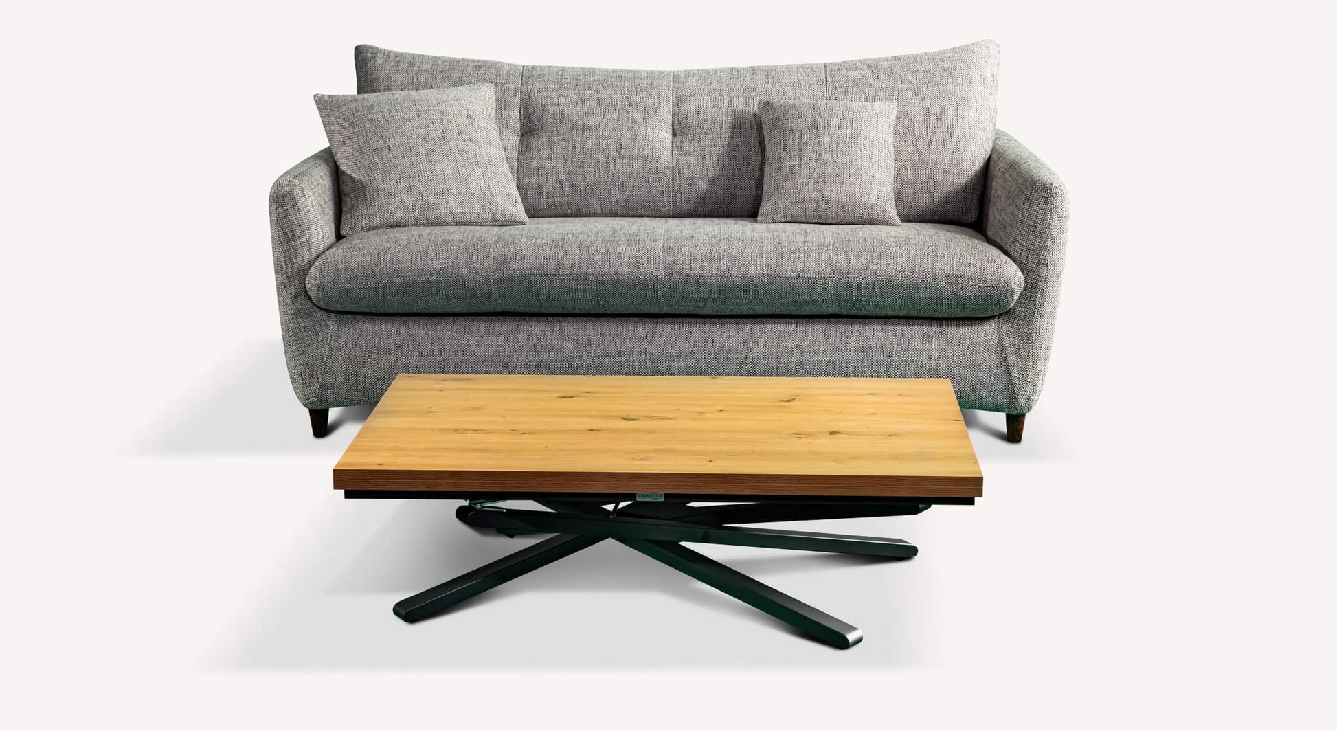Canapé convertible gris avec coussins, accompagné d'une table basse en bois clair et pieds noirs, style moderne et épuré