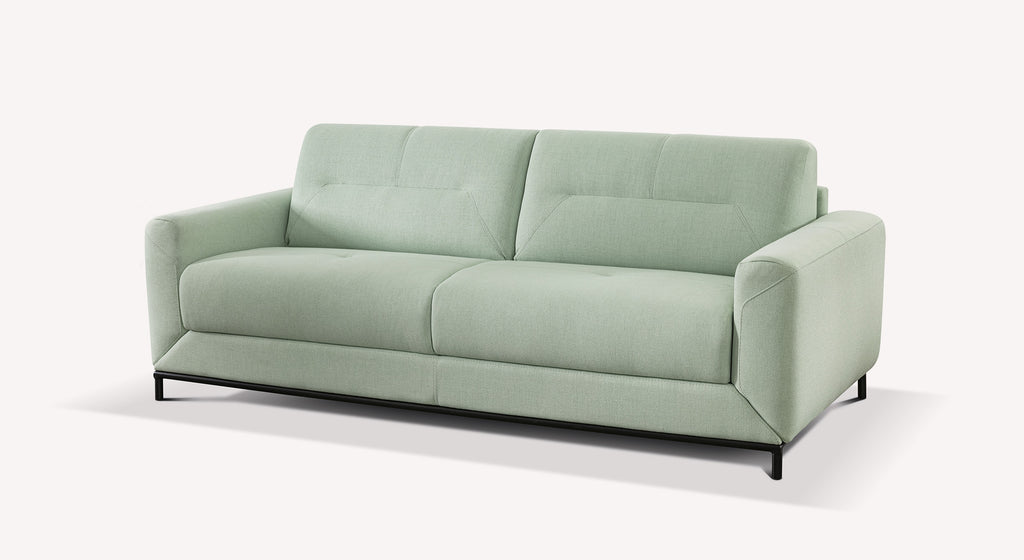 Canapé convertible Gustave en tissu vert amande, design moderne avec accoudoirs épais et pieds noirs
