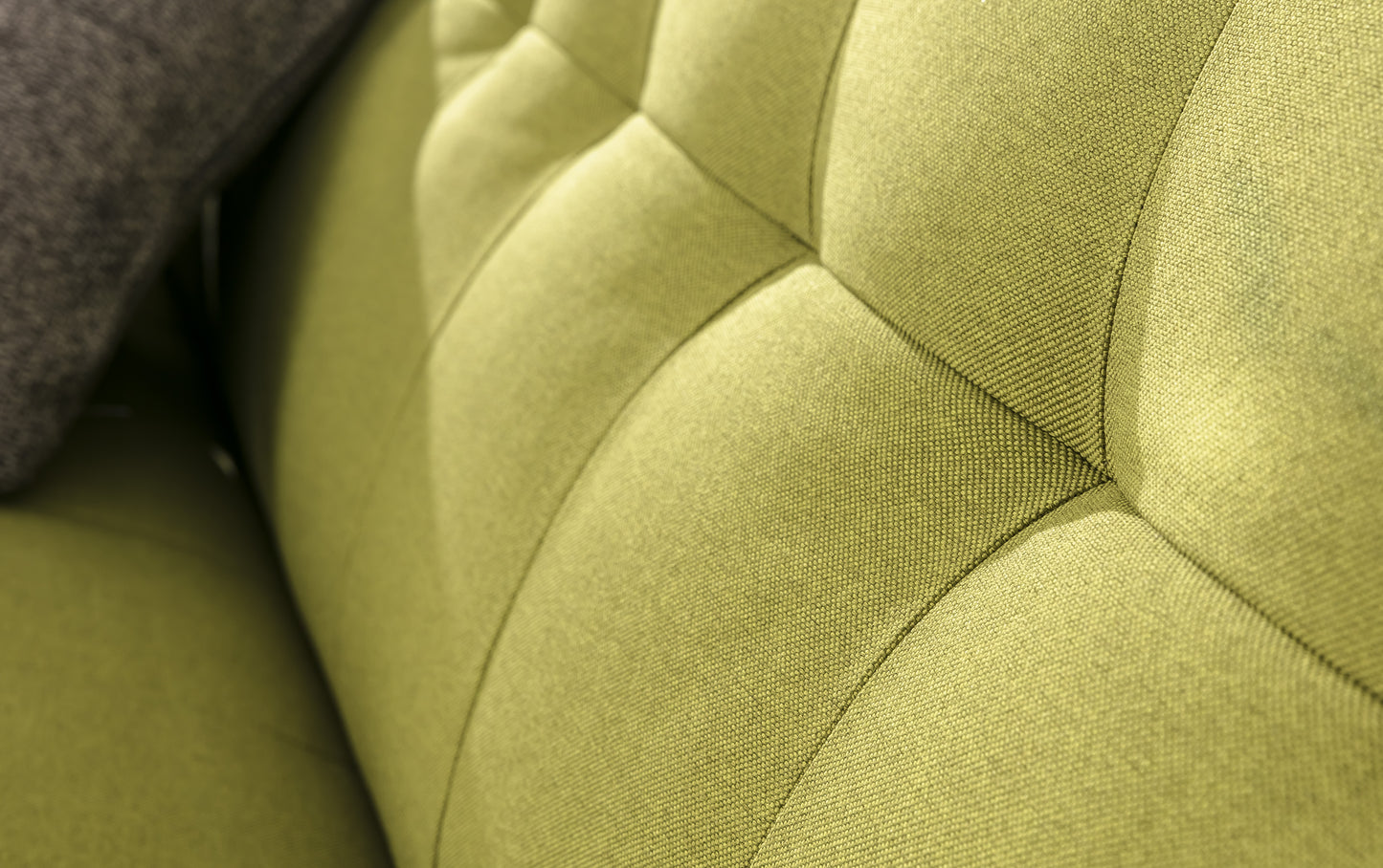 Gros plan sur le tissu vert du canapé convertible Soho, modèle Austin Luna, avec un motif capitonné
