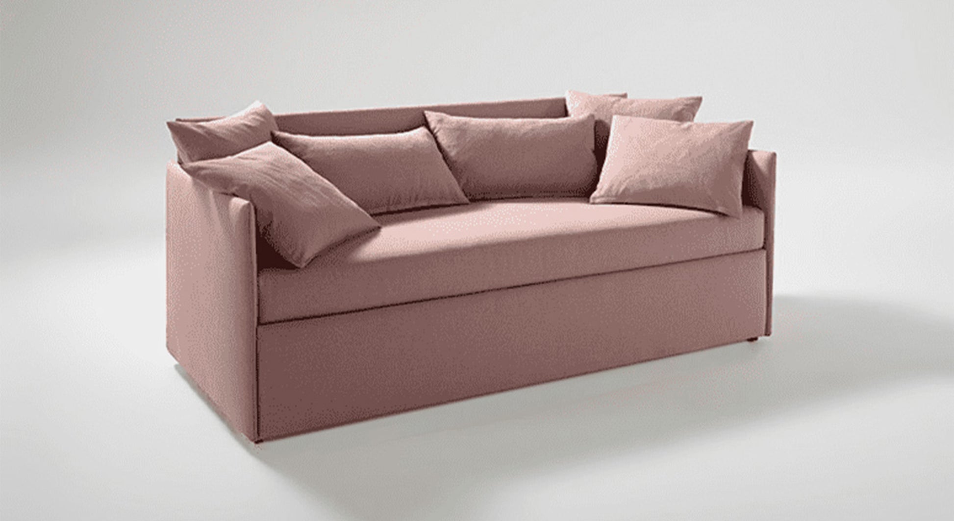 Lit gigogne rose avec coussins, design moderne et ambiance cosy