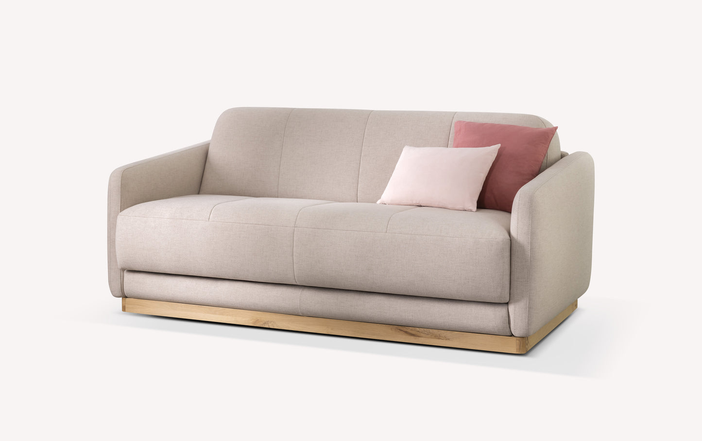 Canapé convertible en tissu mastic avec base en bois, deux coussins roses. Modèle Koons, design moderne et épuré