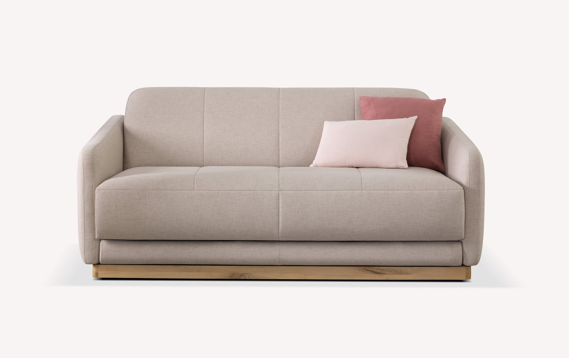 Canapé convertible en tissu mastic avec deux coussins roses, design moderne et base en bois