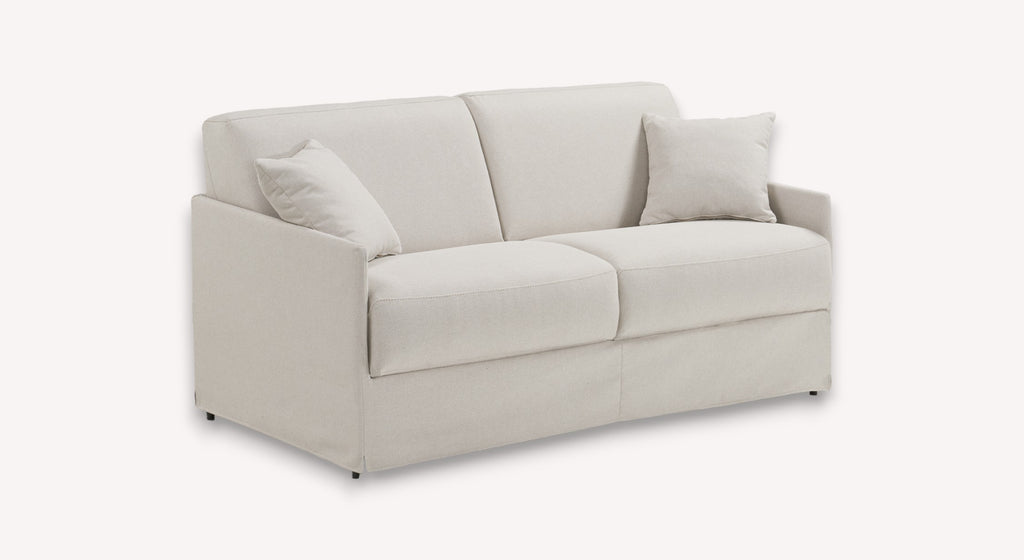 Canapé convertible en tissu ivoire, modèle Lia, avec accoudoirs et deux coussins assortis