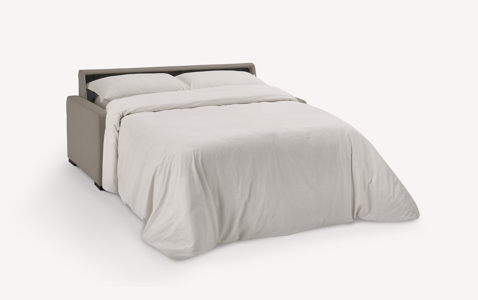 Canapé convertible en cuir gris souris, ouvert en position lit avec draps blancs. Modèle luxueux de Lyon