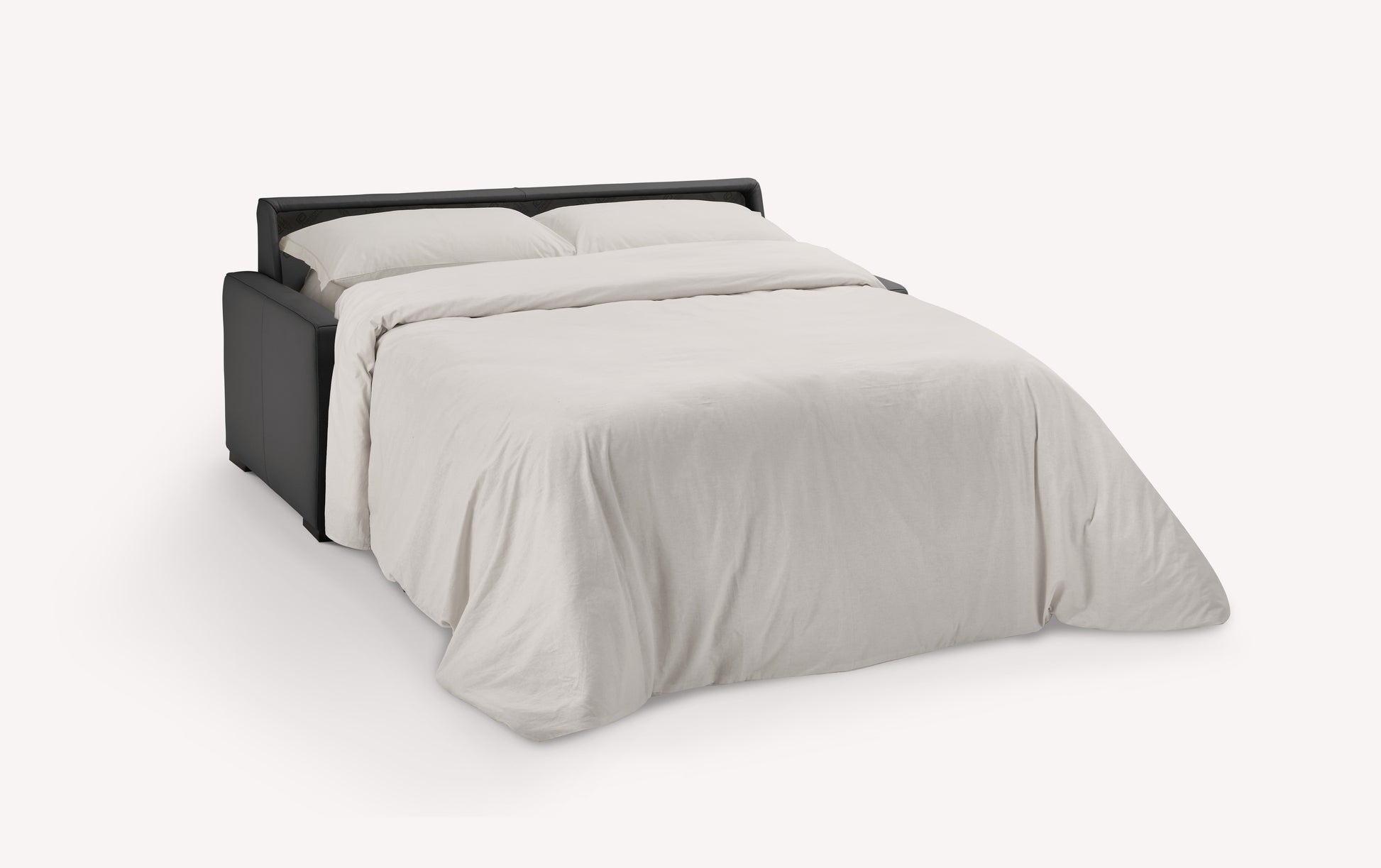 Canapé convertible en cuir noir de luxe, ouvert en position lit avec draps blancs