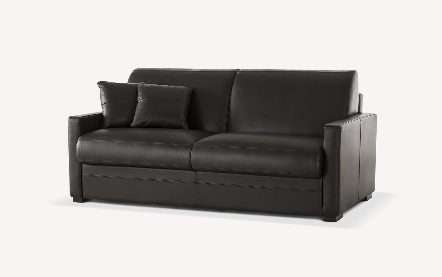 Canapé convertible en cuir noir, modèle Notte Lux, avec deux coussins assortis